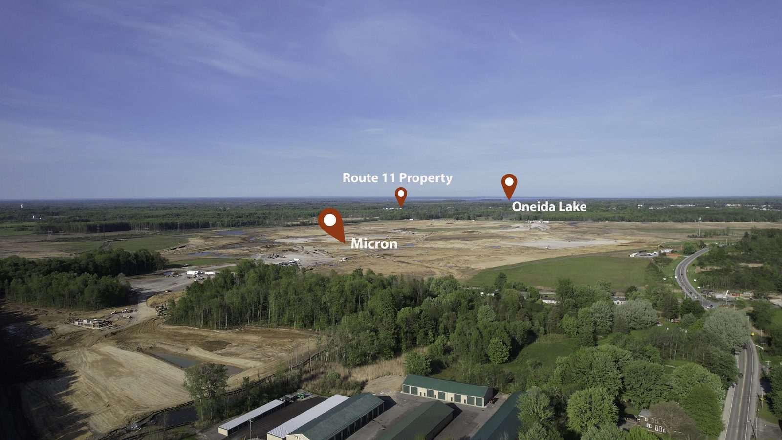 Aerial looking across the planned Micron site, with markers identifying Micron, the Route 11 property and Oneida Lake
